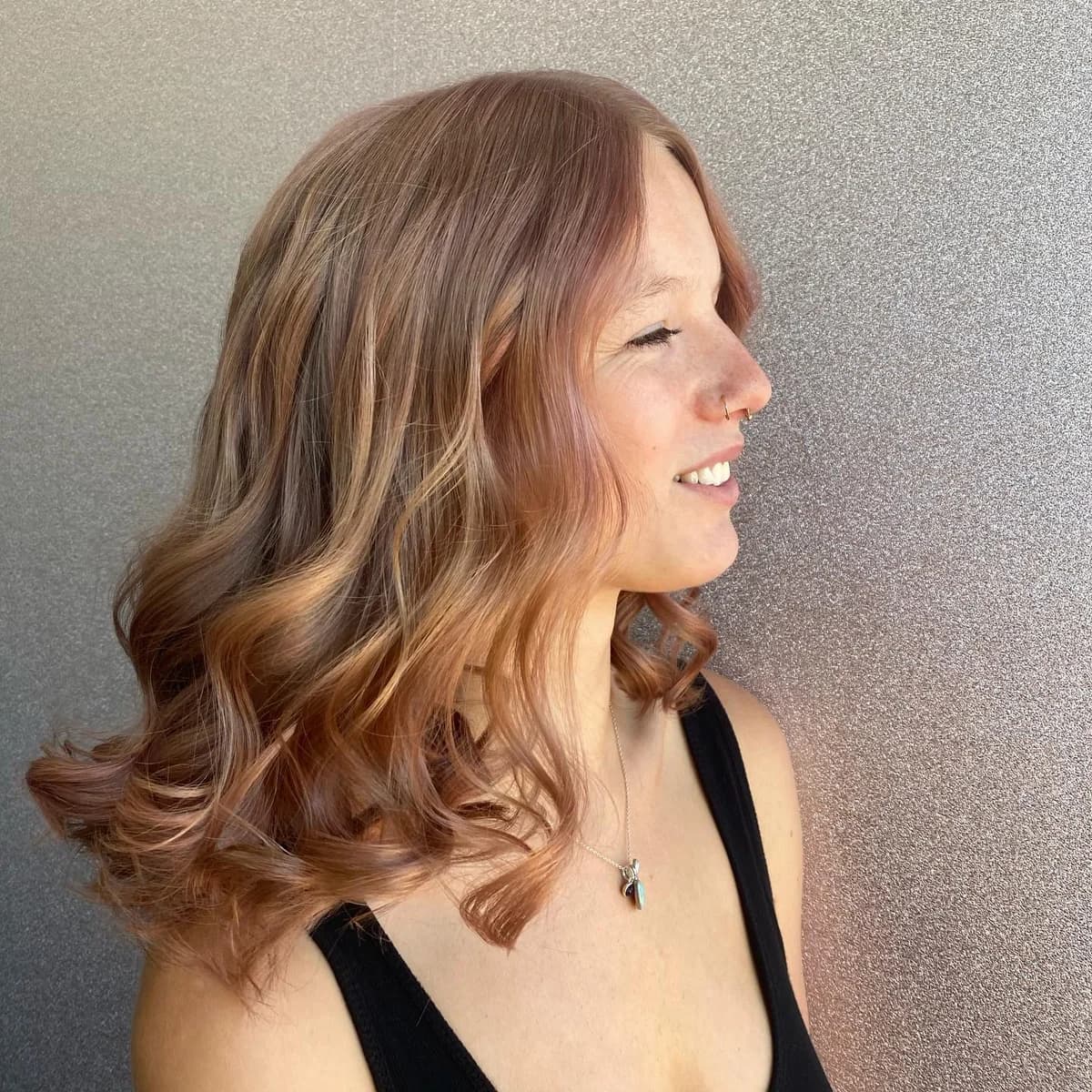 Warm brunette hair with a soft curled finish